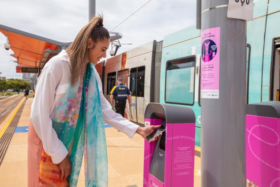 Image of Taliqua Clancy, touching a device to a Smart Ticketing reader